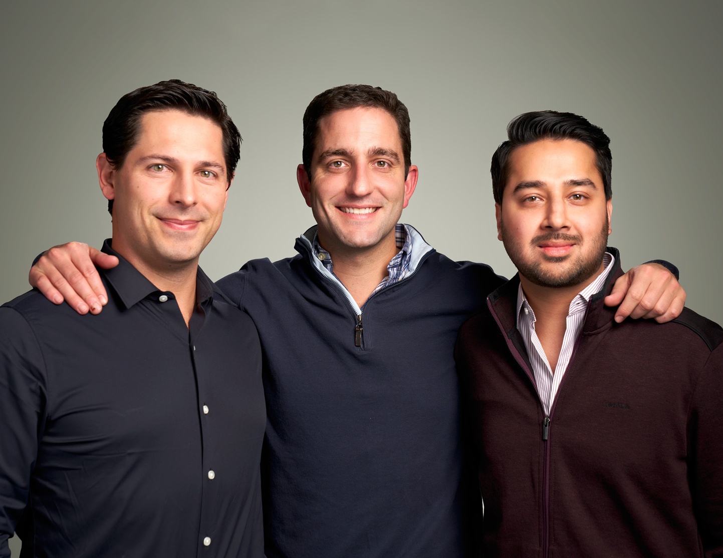 Three Hunt Club founders standing together with their arms around one another