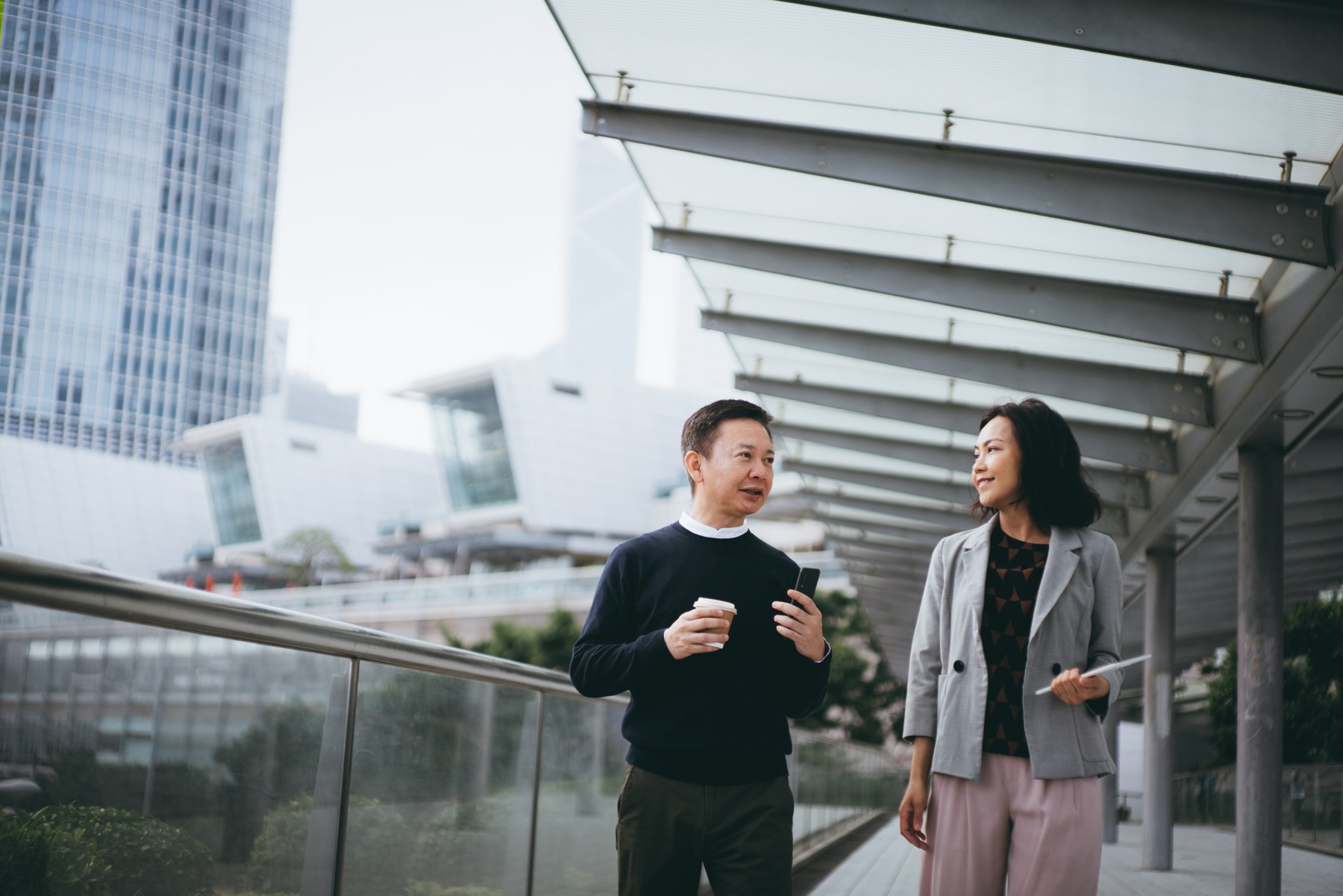 Two people talking on an outdoor walkway in Huron’s corporate careers photograph