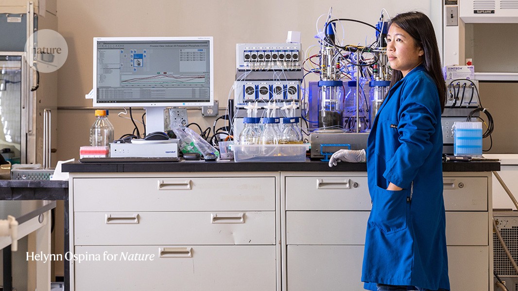 Tammy Hsu in a laboratory beside bioprocess equipment