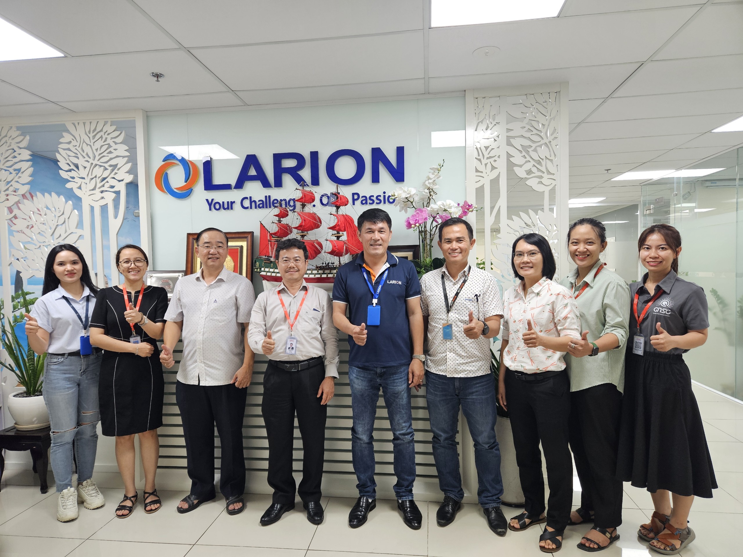 Huy Nguyen, centre in a navy LARION polo shirt, with business leaders and colleagues during a QTSC visit