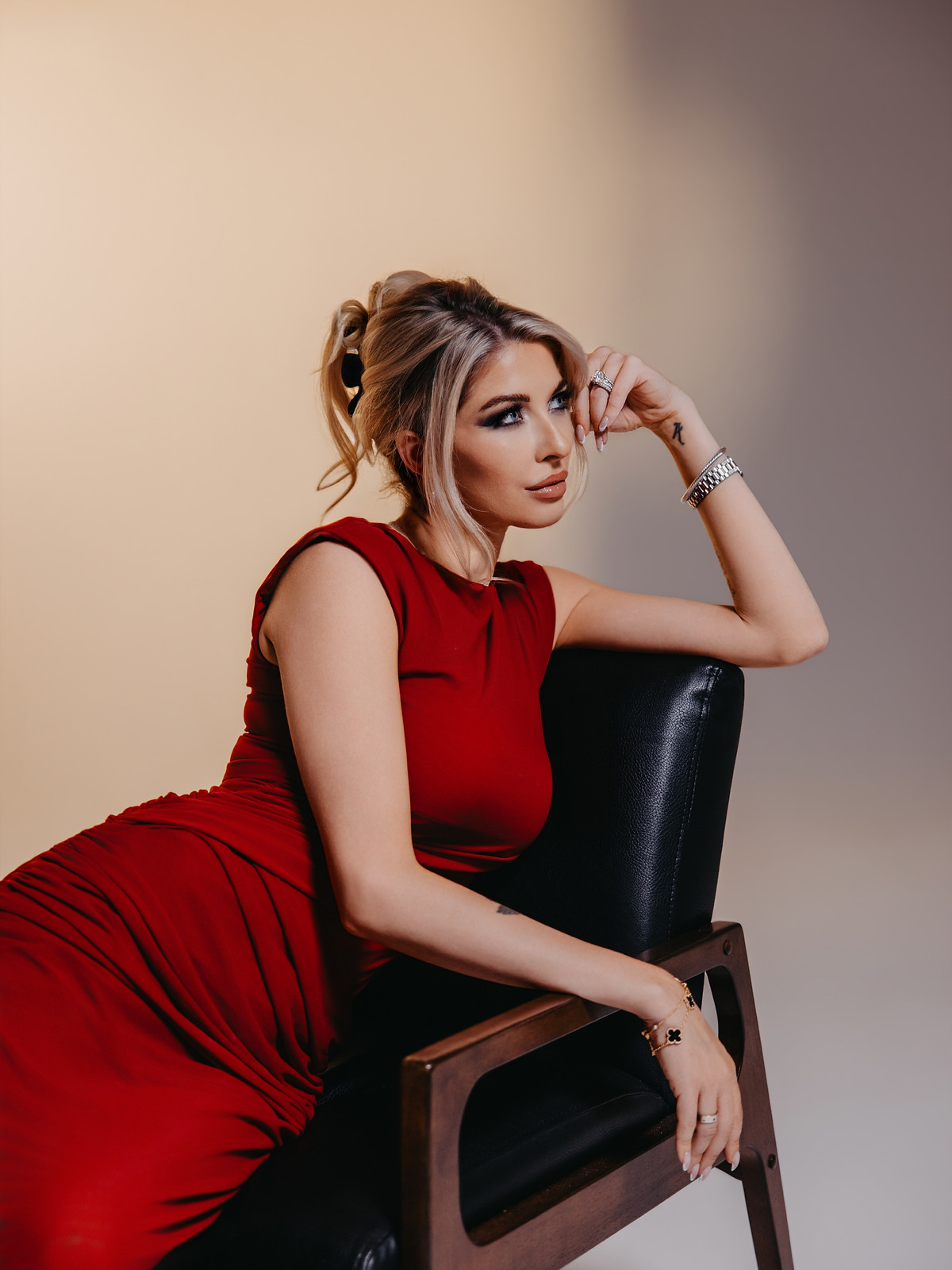 HVH Media & Marketing founder Hayden Van Hulzen seated in a red dress