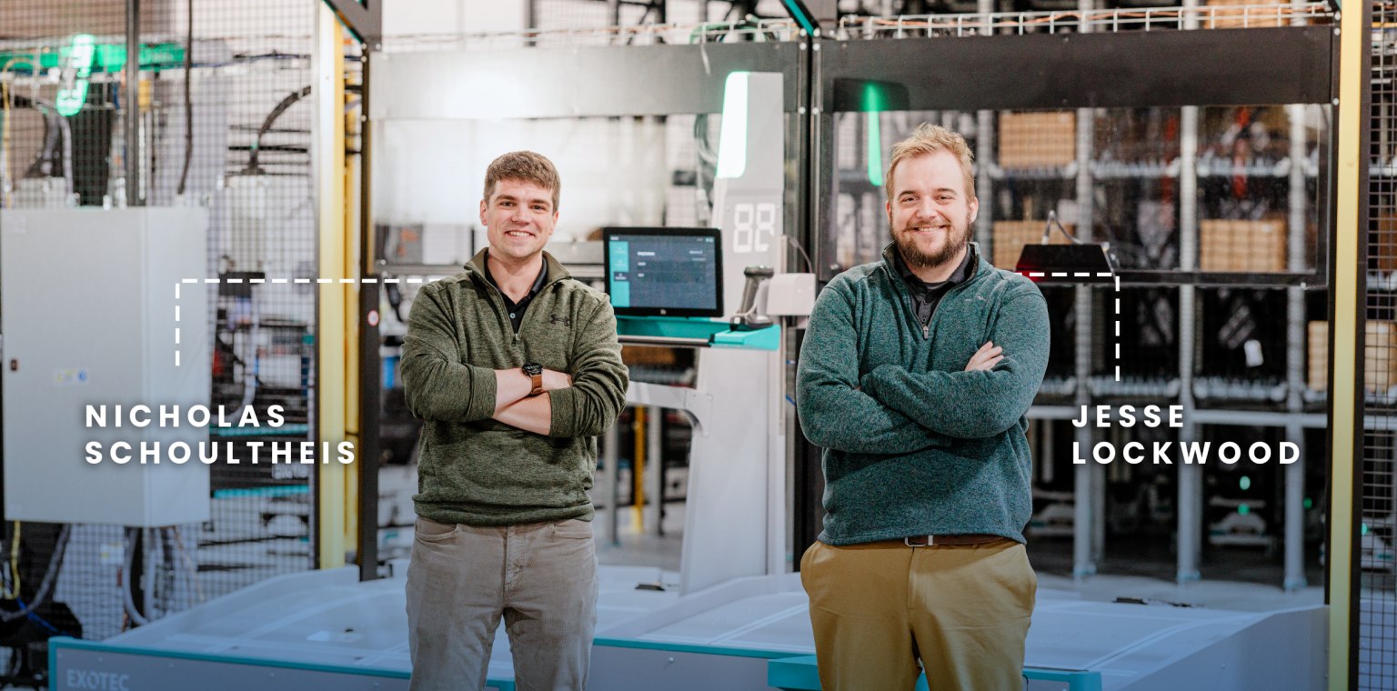 Hy-Tek engineers Nicholas Schoultheis and Jesse Lockwood standing among automation equipment in the Innovation Lab