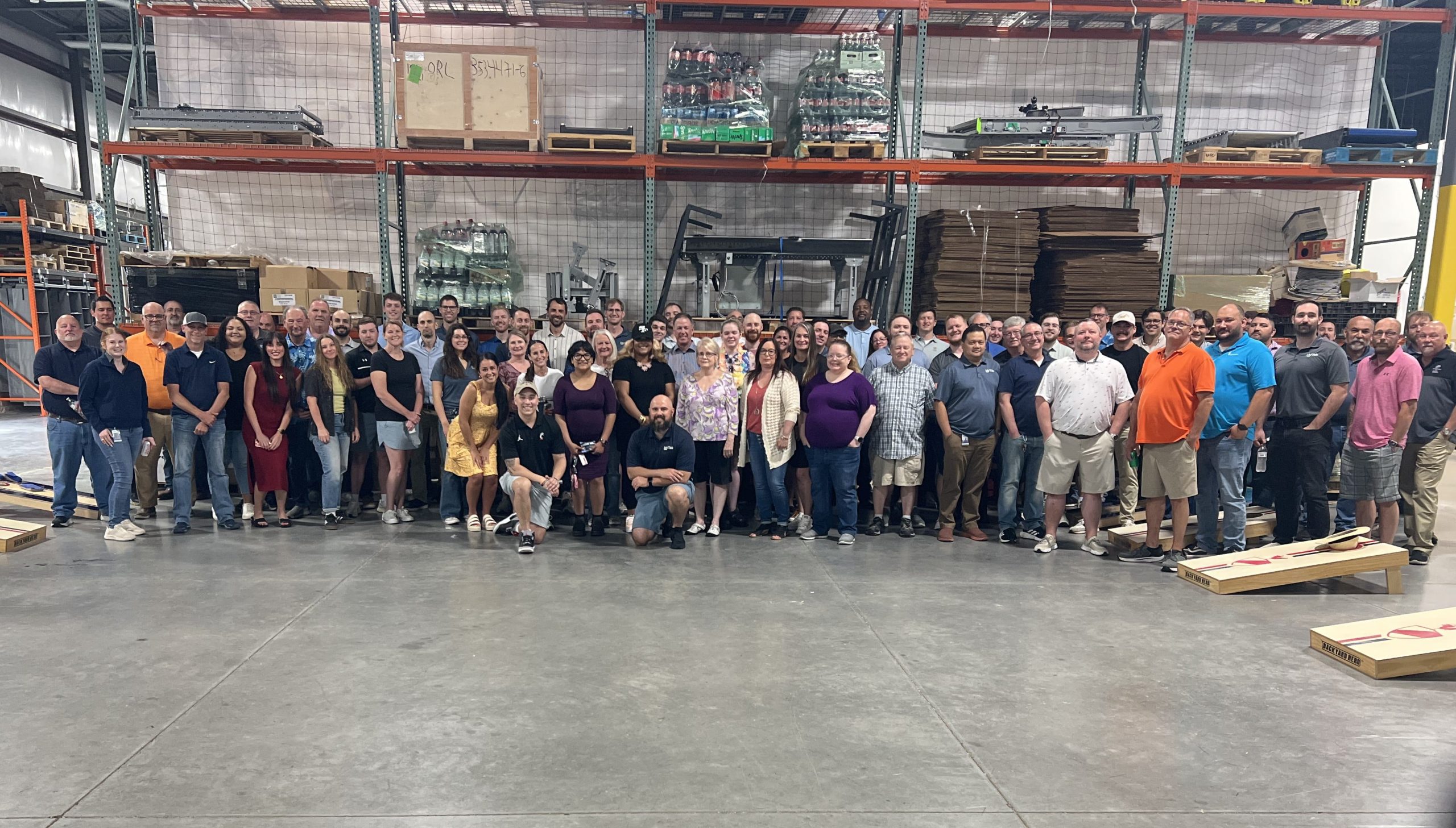 Hy-Tek employees gathered on a warehouse floor for National Warehouse Workers Day