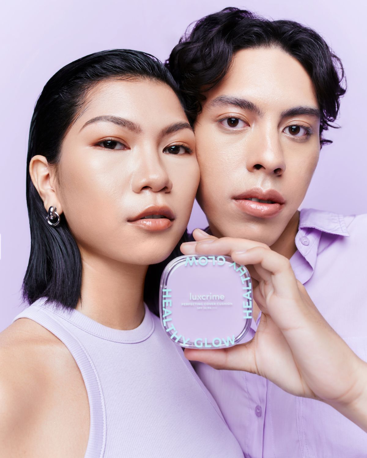 Two models holding a lavender Luxcrime Perfecting Cover Cushion compact