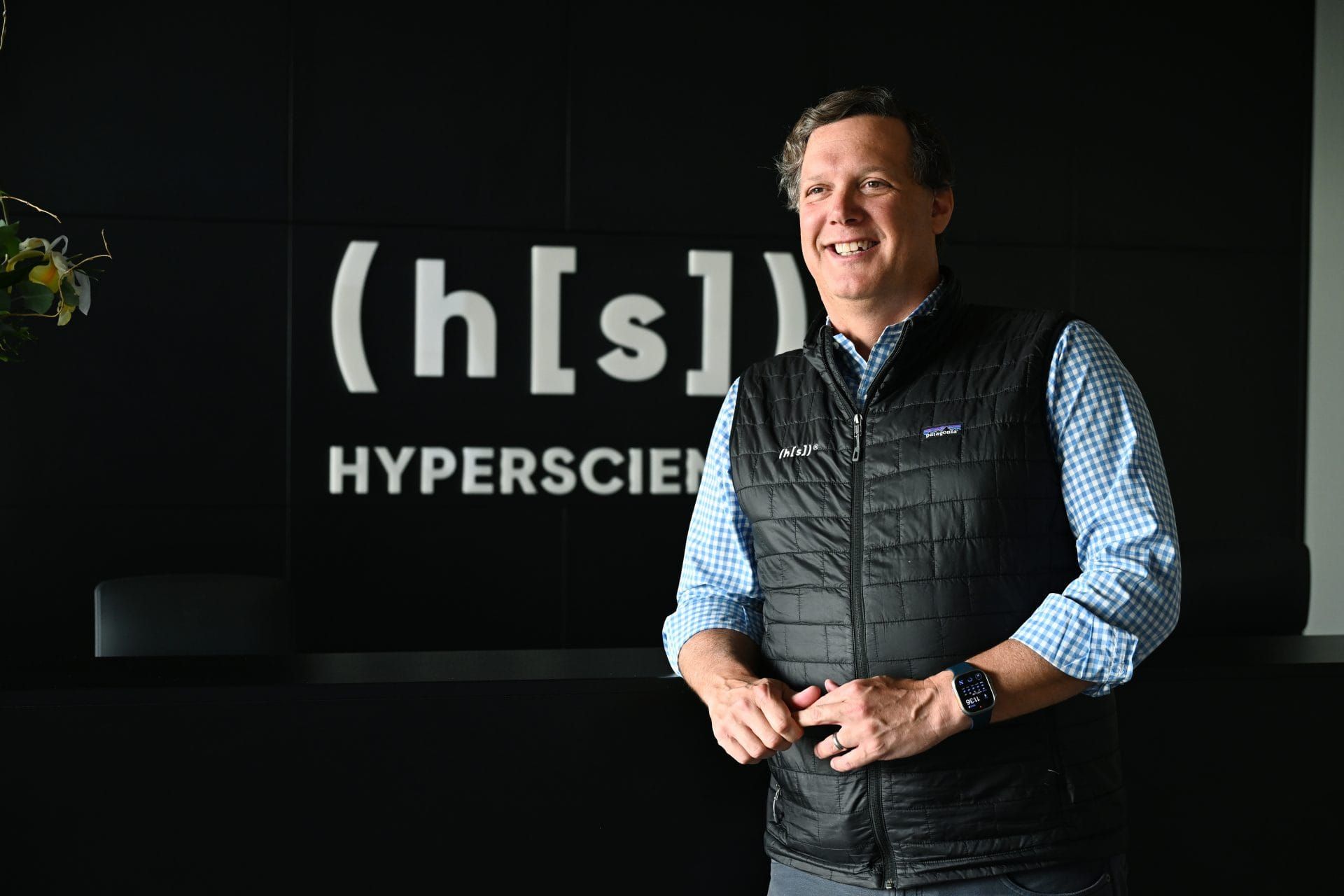 Hyperscience CEO Andrew Joiner wearing a checked shirt and dark vest