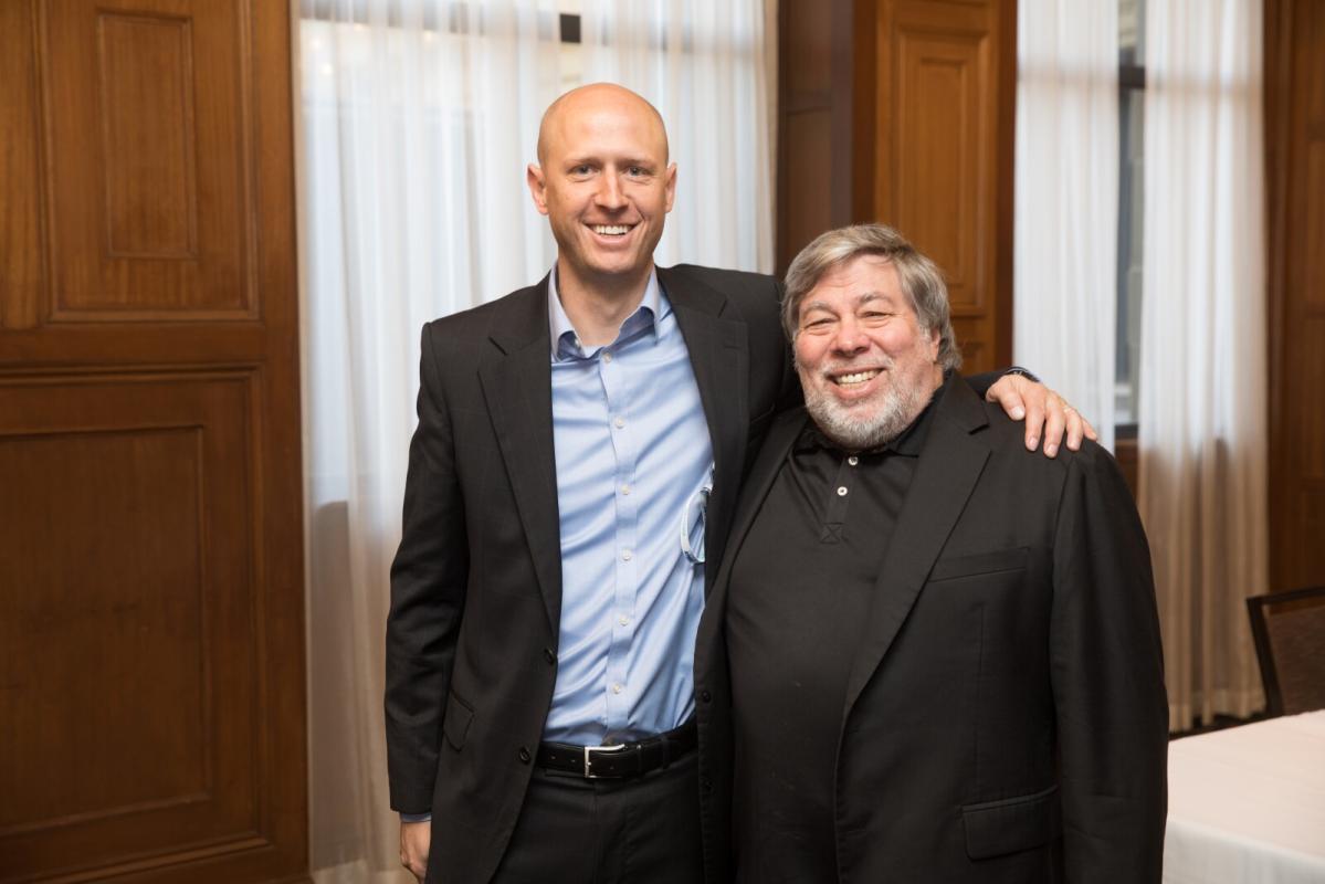 Hyrum Kirton, left, smiling alongside Steve Wozniak at a Coupa event