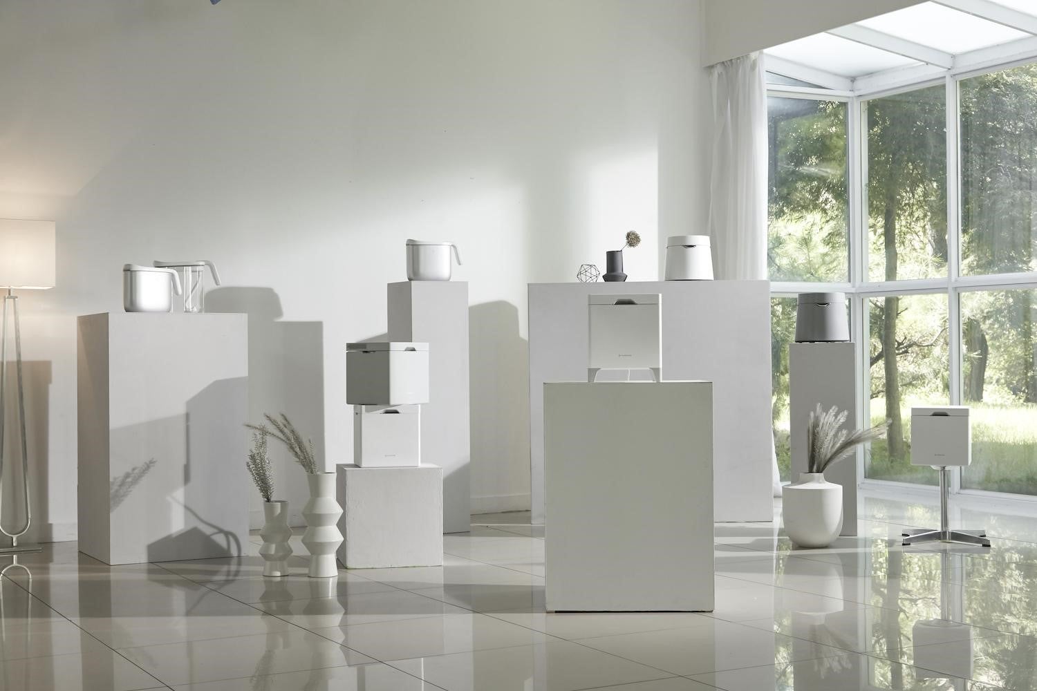 Carepod humidifiers and detachable tanks displayed on plinths in a bright room