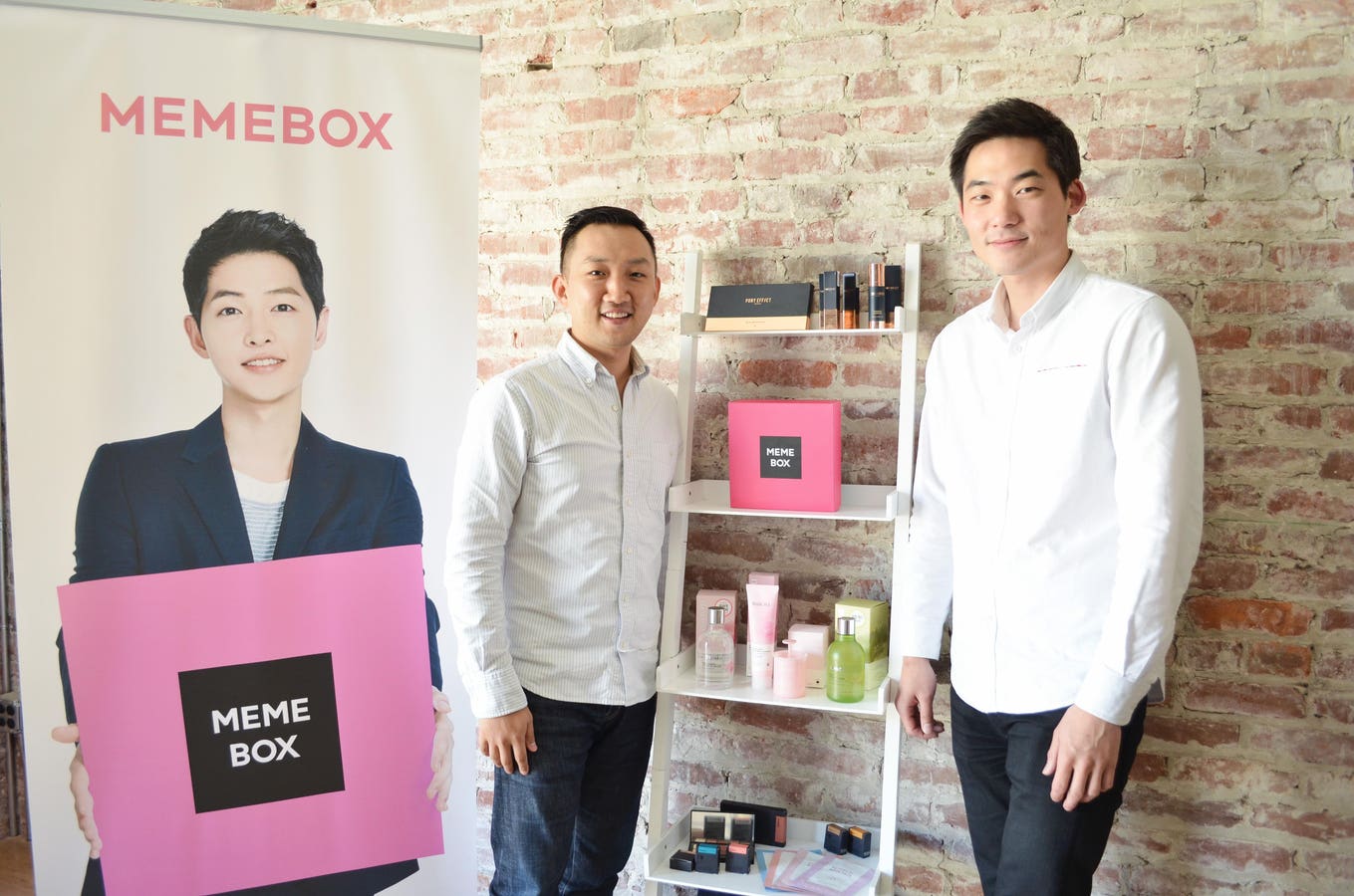 Hyungseok Dino Ha and Memebox co-founder Arnold Hur standing beside early Memebox products