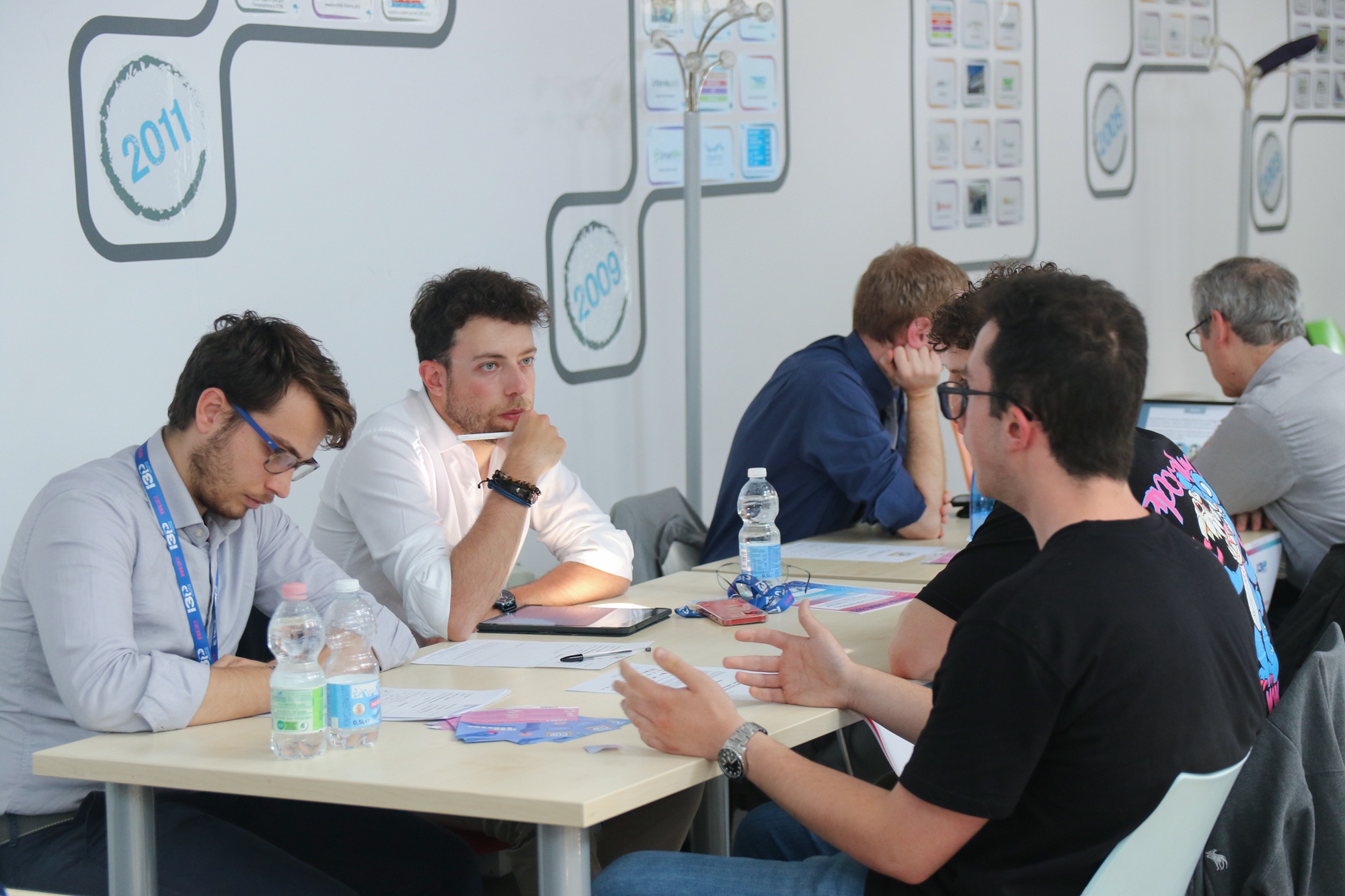 Participants discussing ideas around a table at an I3P workshop