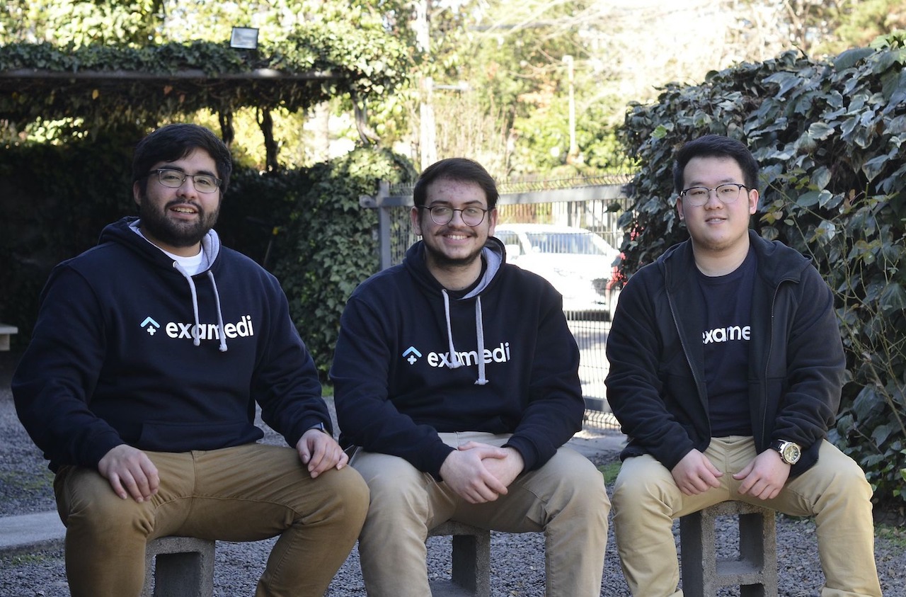 Three Examedi founders sitting together outdoors, with Ian Lee at right