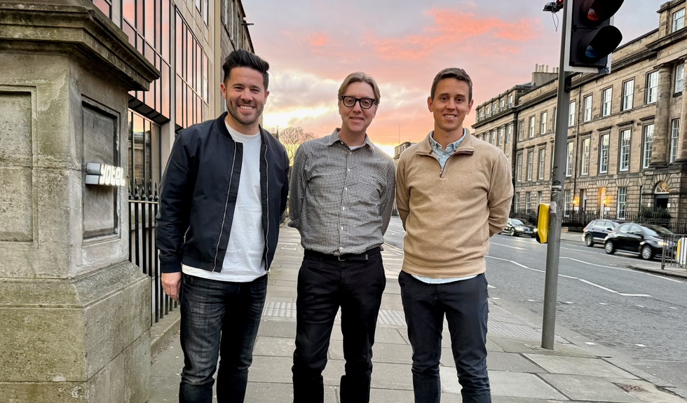 Ian Shepherd, Tim Shey and Owen Maher standing together on a city pavement