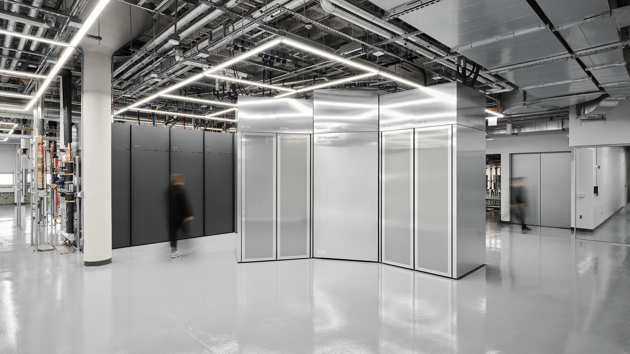 People beside IBM Quantum System Two in the Poughkeepsie data center