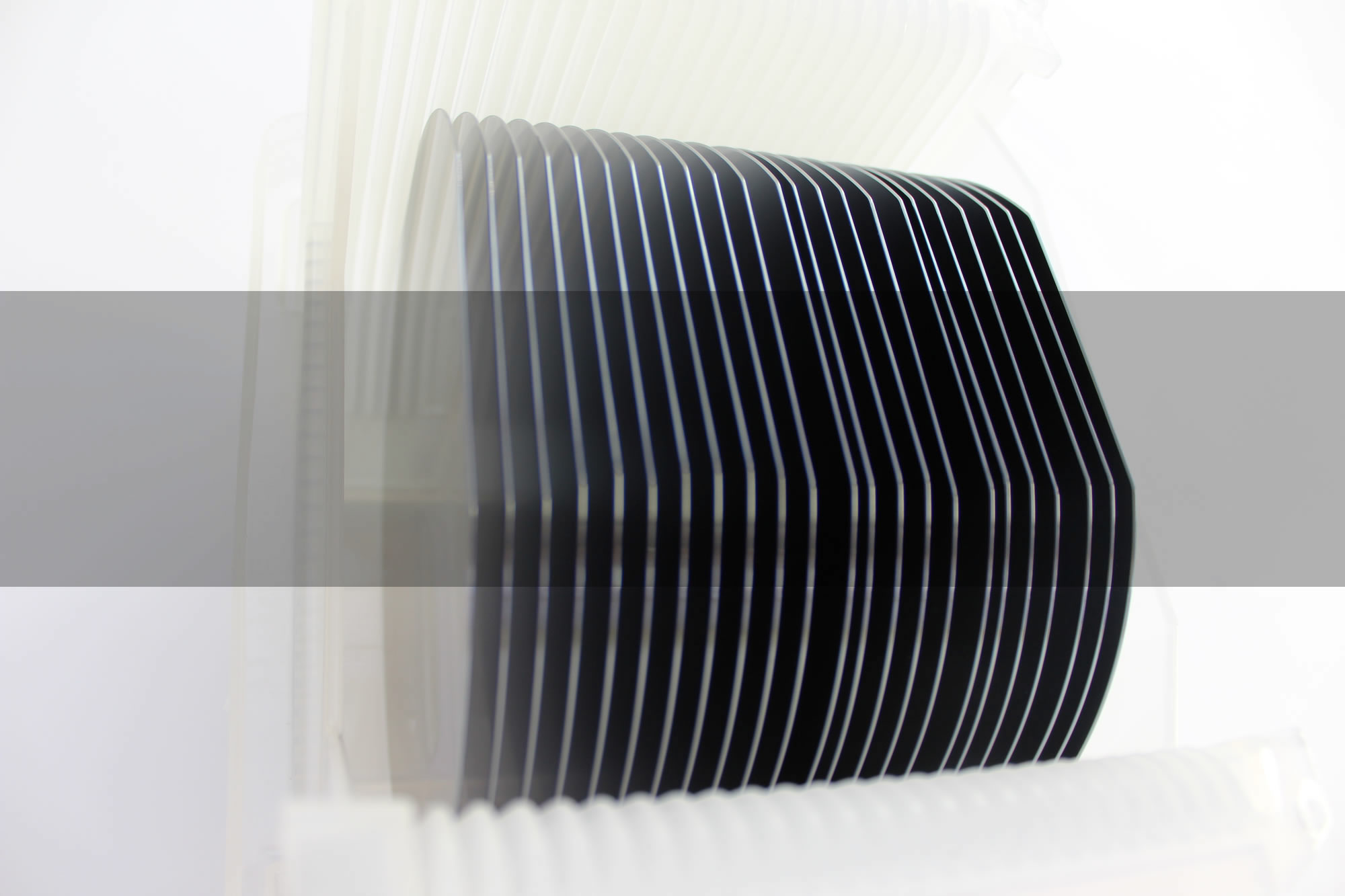 Silicon wafers held vertically in a carrier, photographed for the IceMOS website