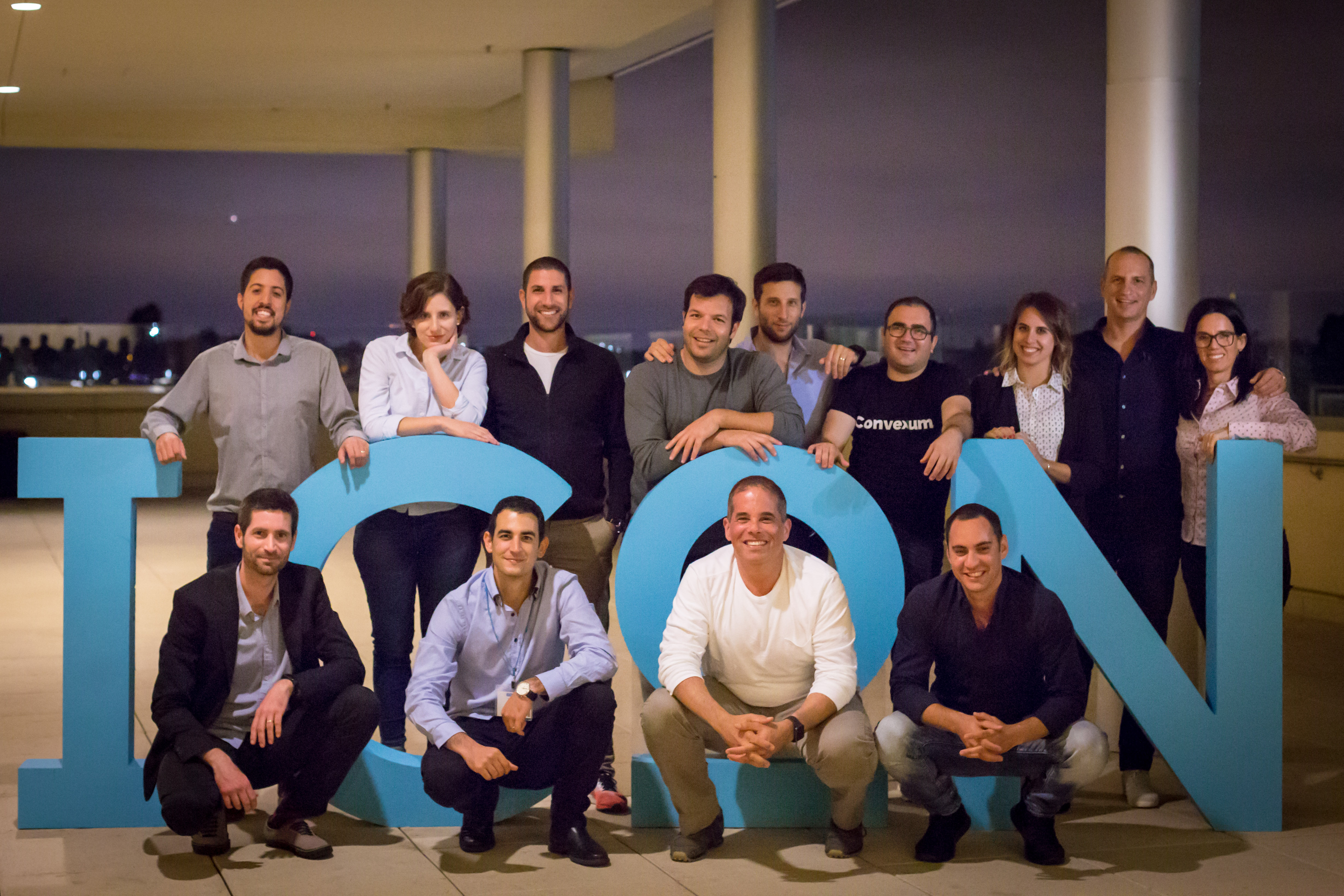 SV101 group gathered behind oversized blue ICON letters