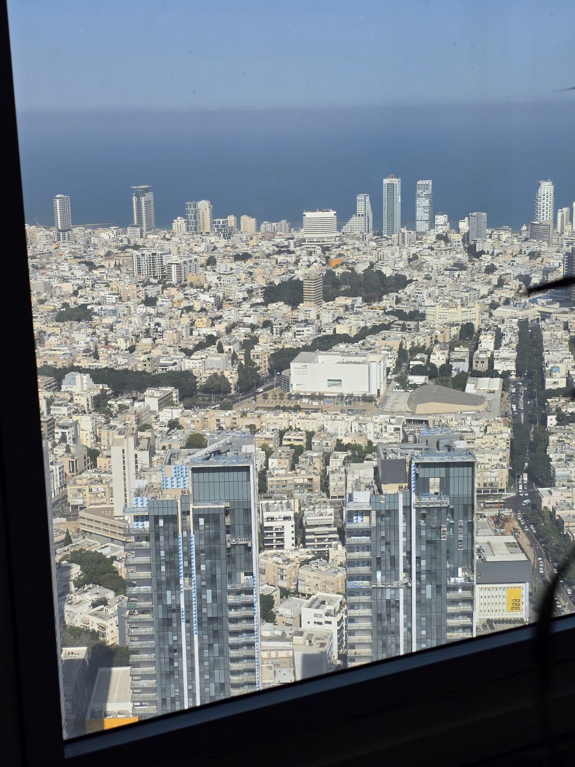 Tel Aviv skyline and Mediterranean Sea photographed through an office window