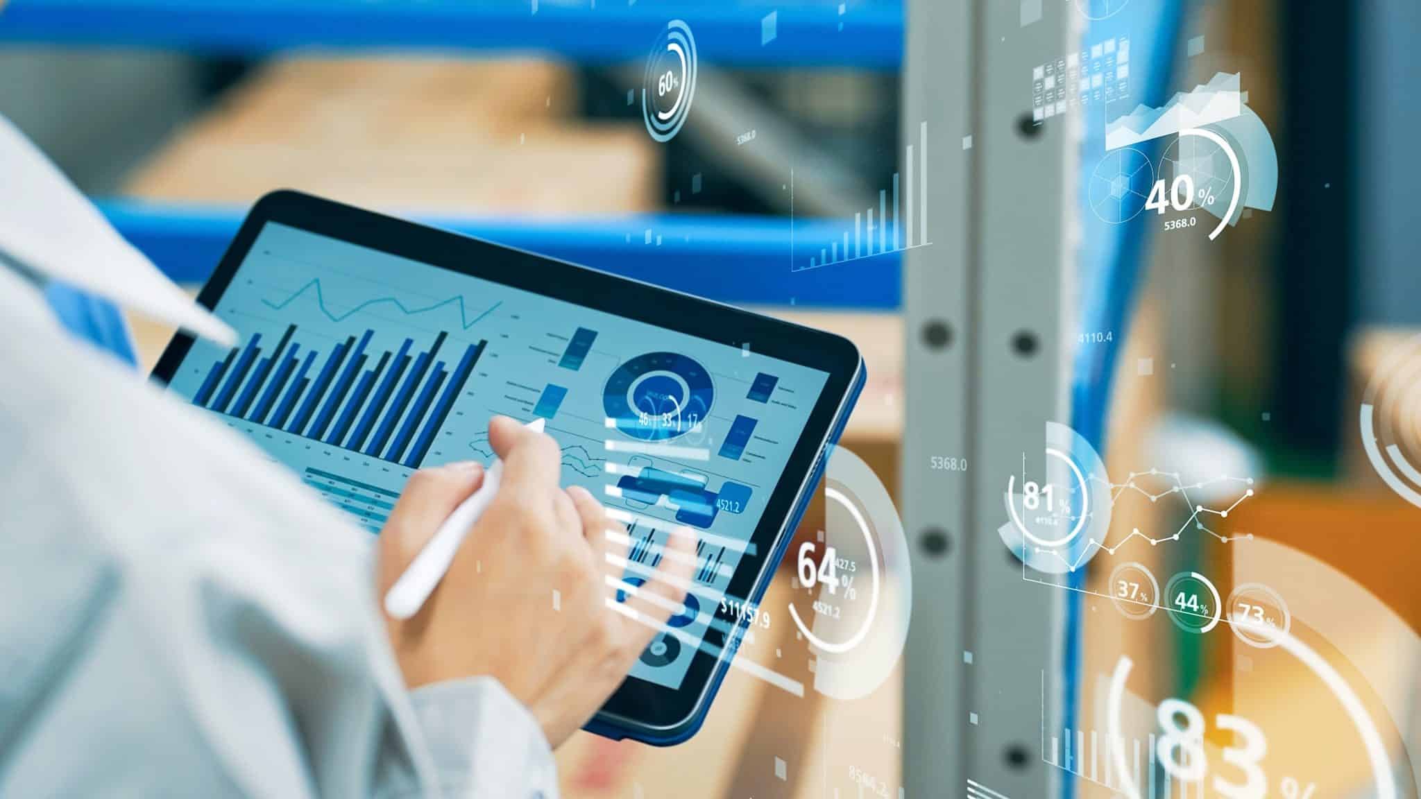 IDBS promotional image of a tablet displaying charts, with data graphics overlaid