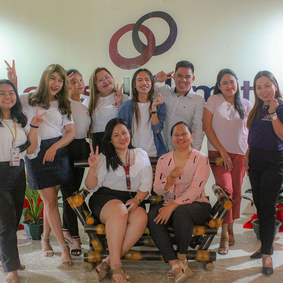 IdeasUnlimited colleagues gathered for a group photograph at a company office