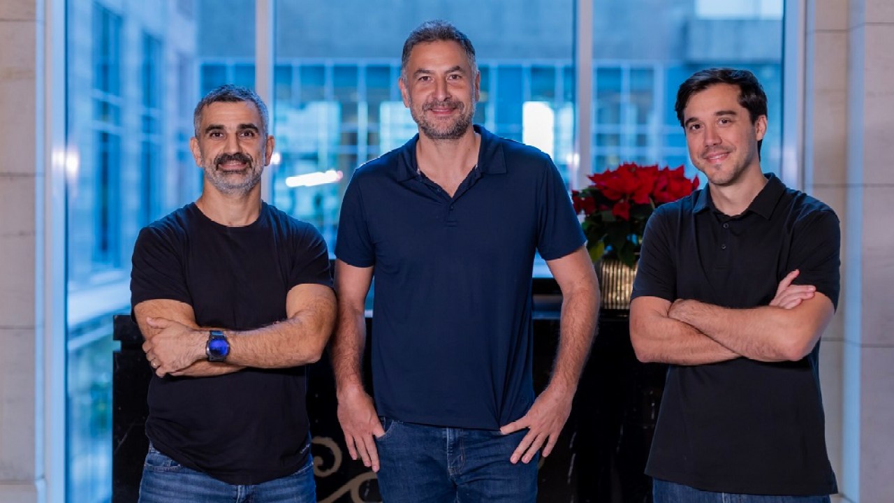 Idriss Al Rifai, centre, with two Flow48 colleagues in a team photograph