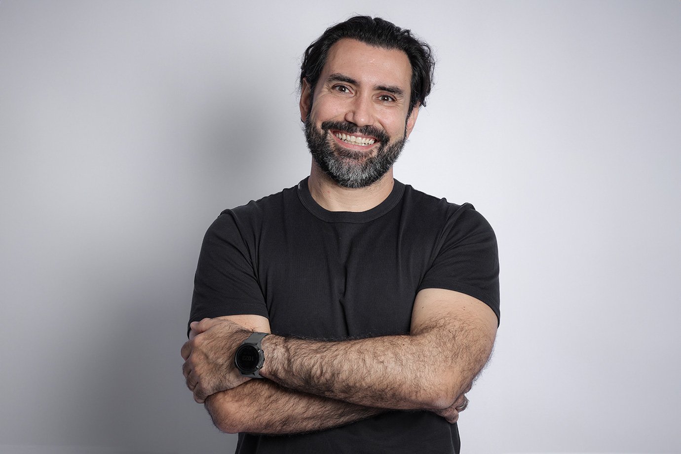 Diego Barreto, iFood CEO, wearing a black T-shirt and smiling with his arms folded.