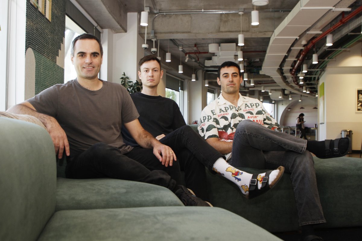 The three Perhaps co-founders seated together on a green sofa