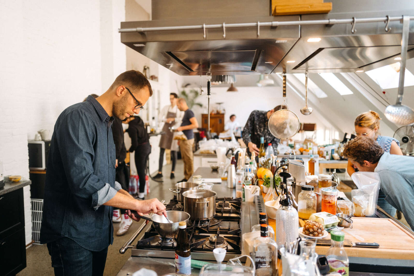 Lab56 participants preparing ingredients and experiments in a working kitchen