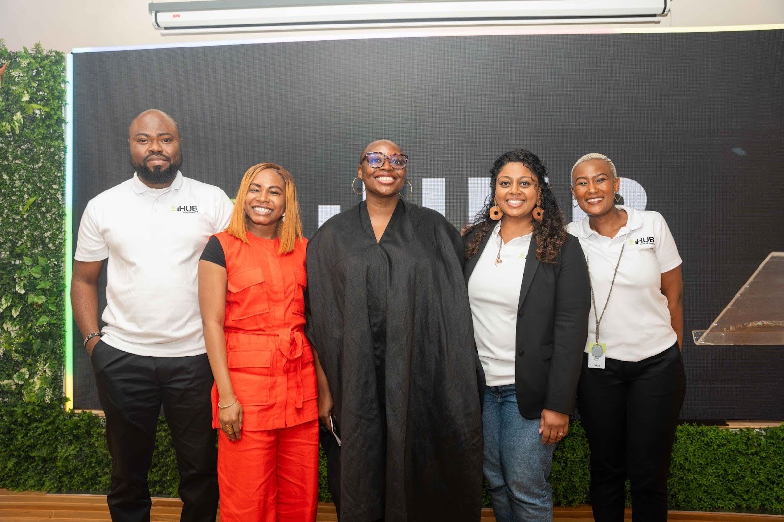 Five people posing together at the iHUB and CcHUB event pictured in the November 2024 announcement