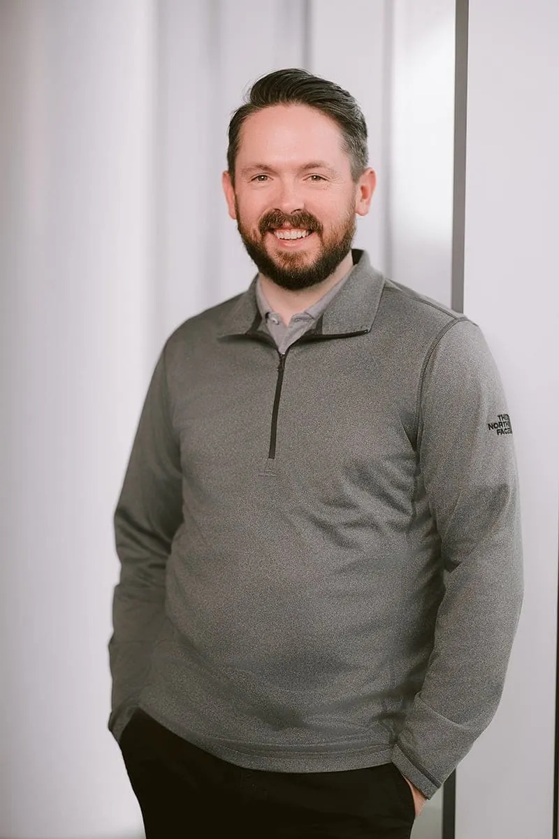 AssetWatch co-founder Will Zell standing beside a window