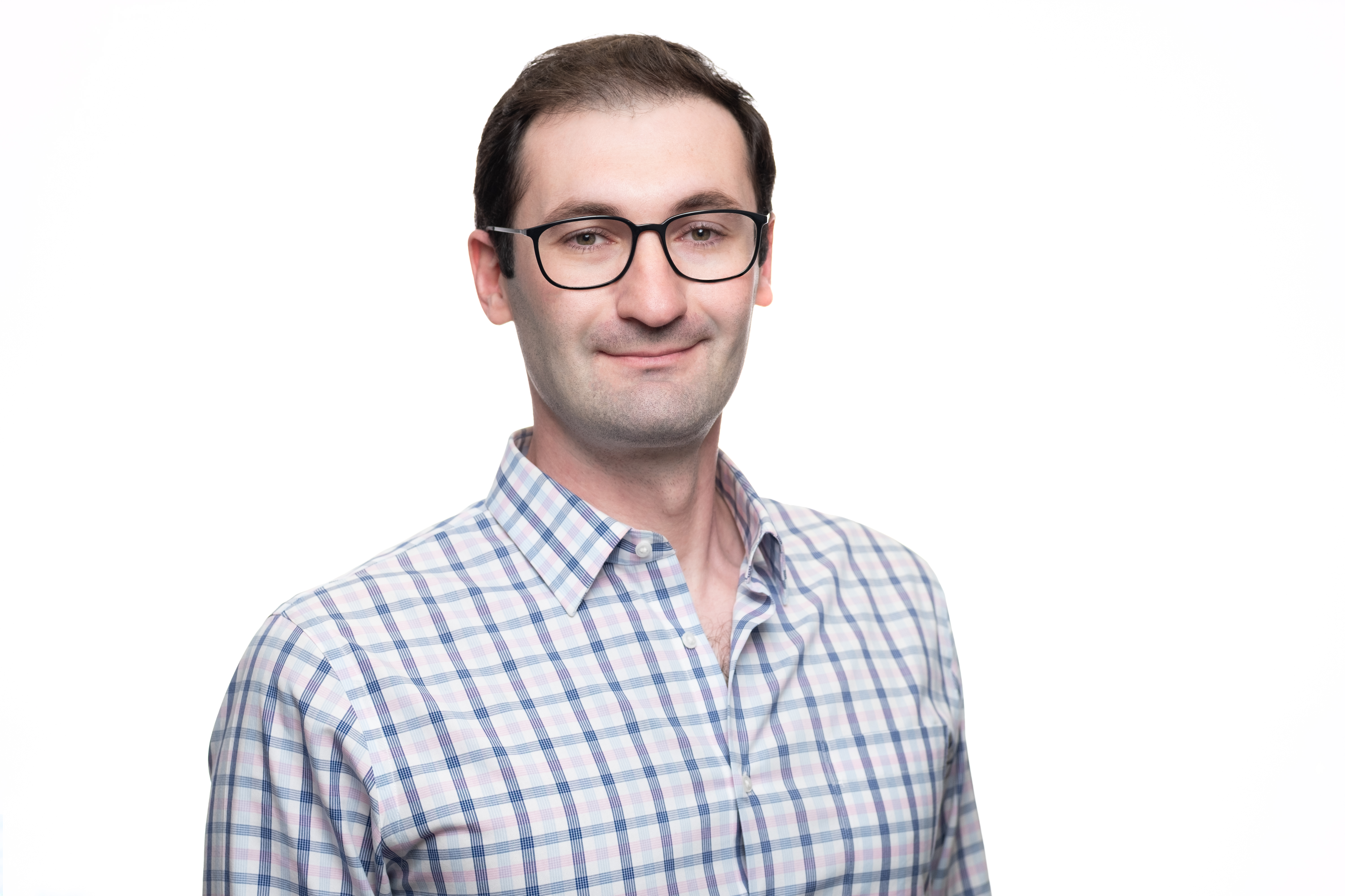 Archival press photograph of Ilya Bodner wearing glasses and a checked shirt