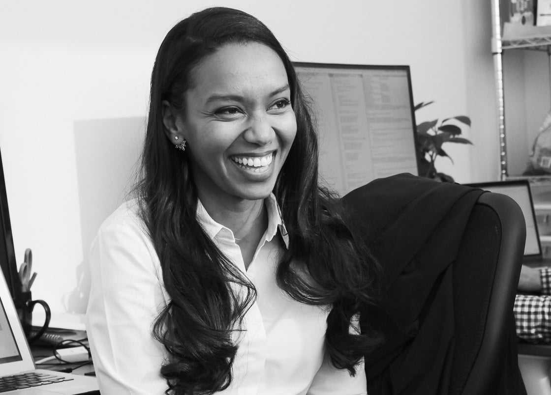 Iman Abuzeid smiling while seated in an office