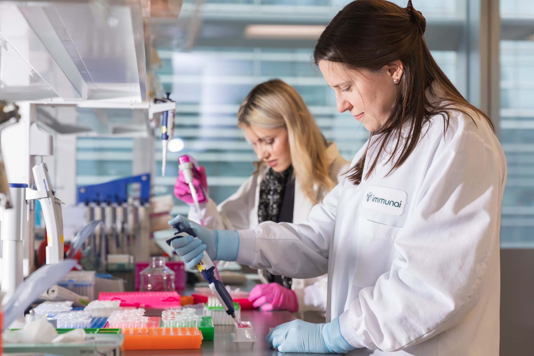 Two Immunai researchers working with pipettes in a laboratory
