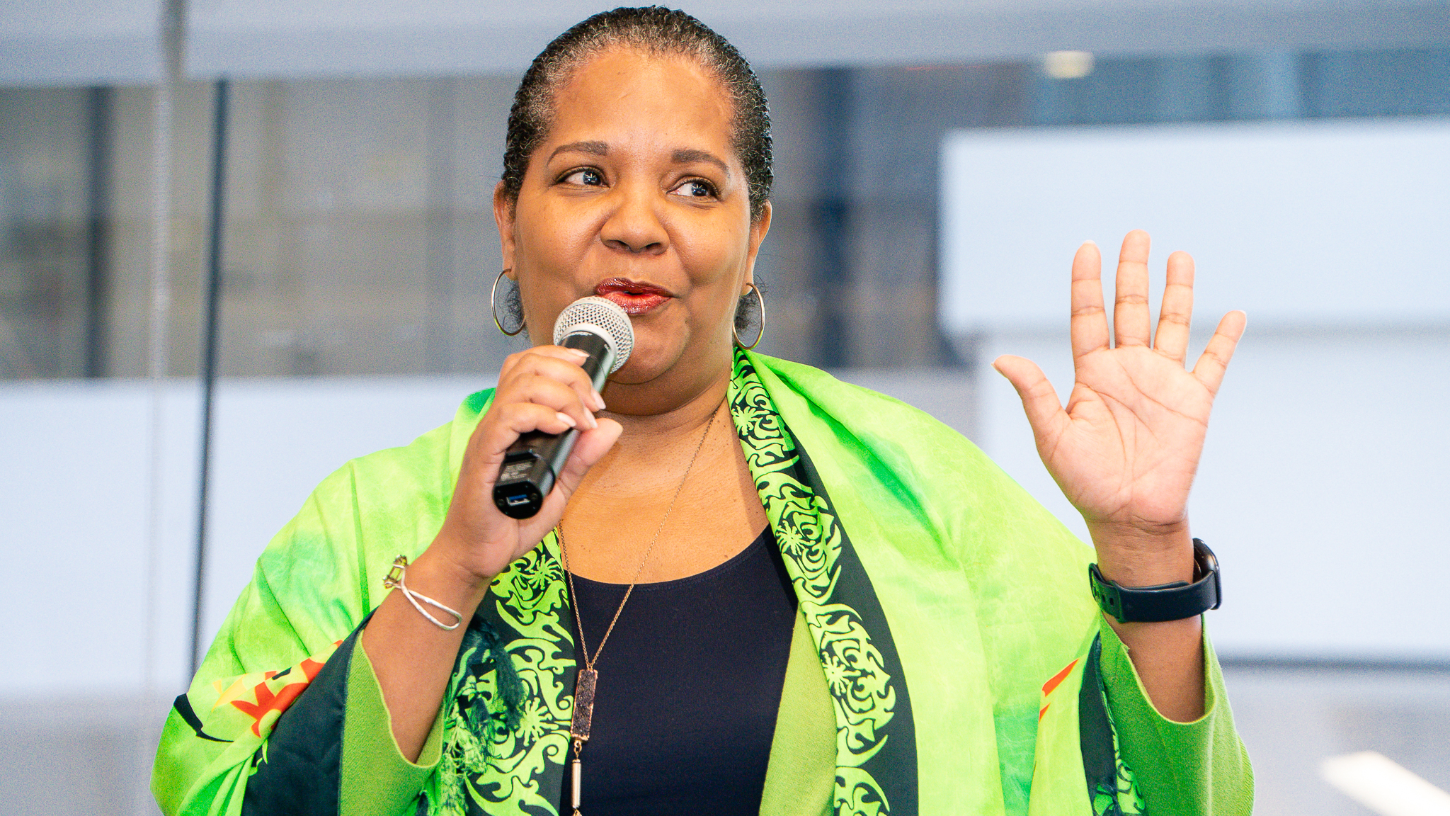 Cheryl McCants speaking into a microphone at an event