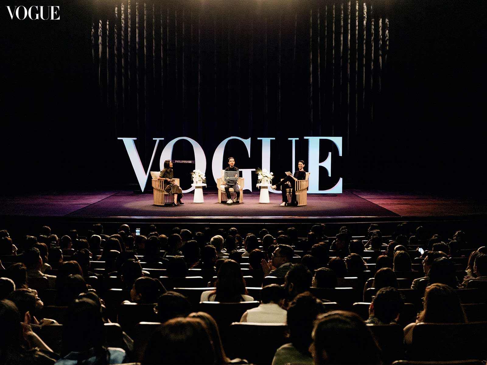 Imran Amed seated between Bea Valdes and Pam Quiñones on the Vogue Talks stage in Manila, with an audience in front.