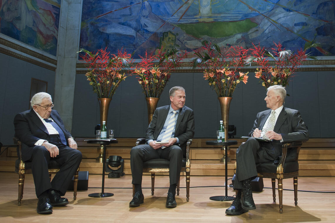 Henry Kissinger and Zbigniew Brzezinski seated with a moderator at the 2016 Nobel Peace Prize Forum Oslo