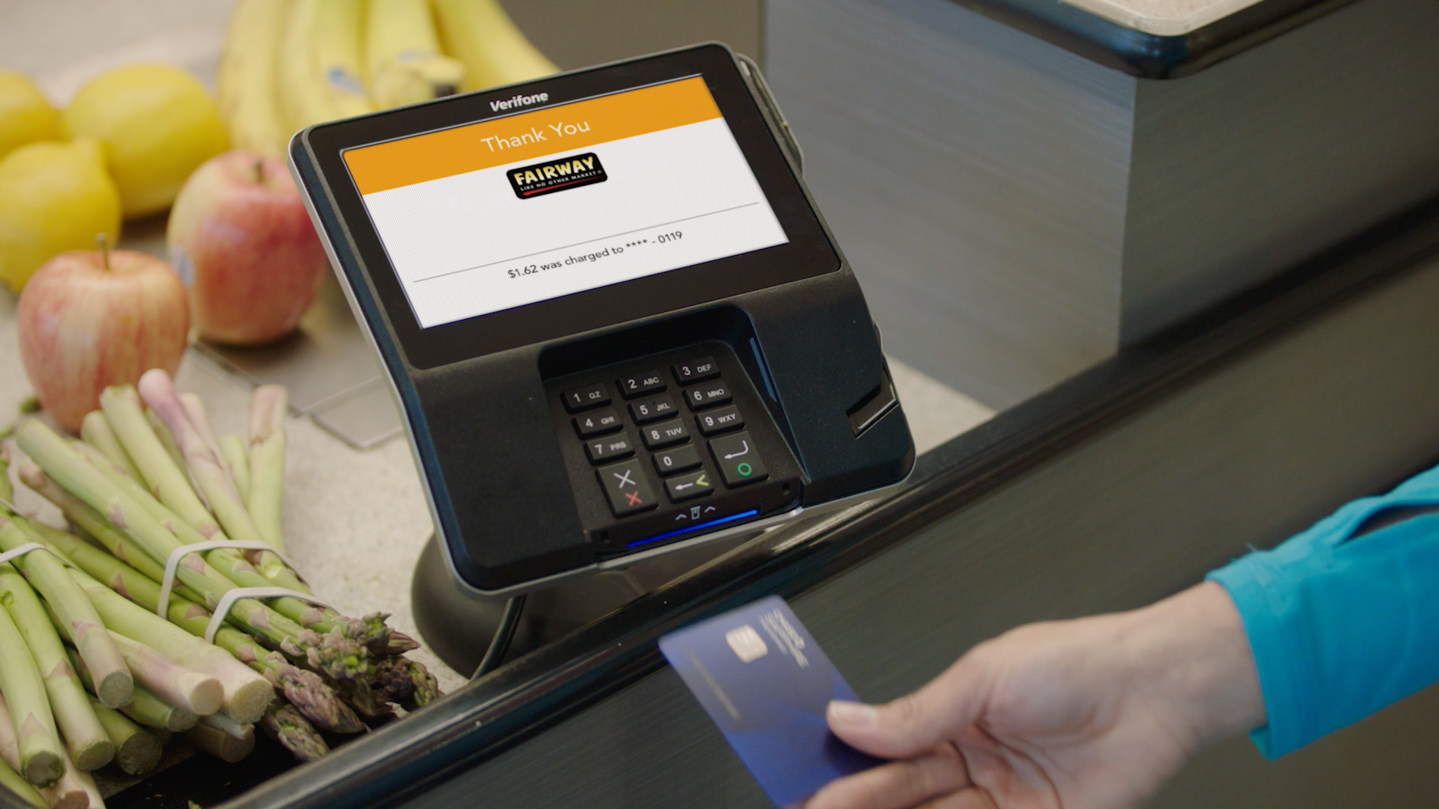 A shopper using an Index-powered Verifone terminal at Fairway Market