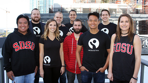 Nine members of Industry’s early team standing together outdoors in 2016
