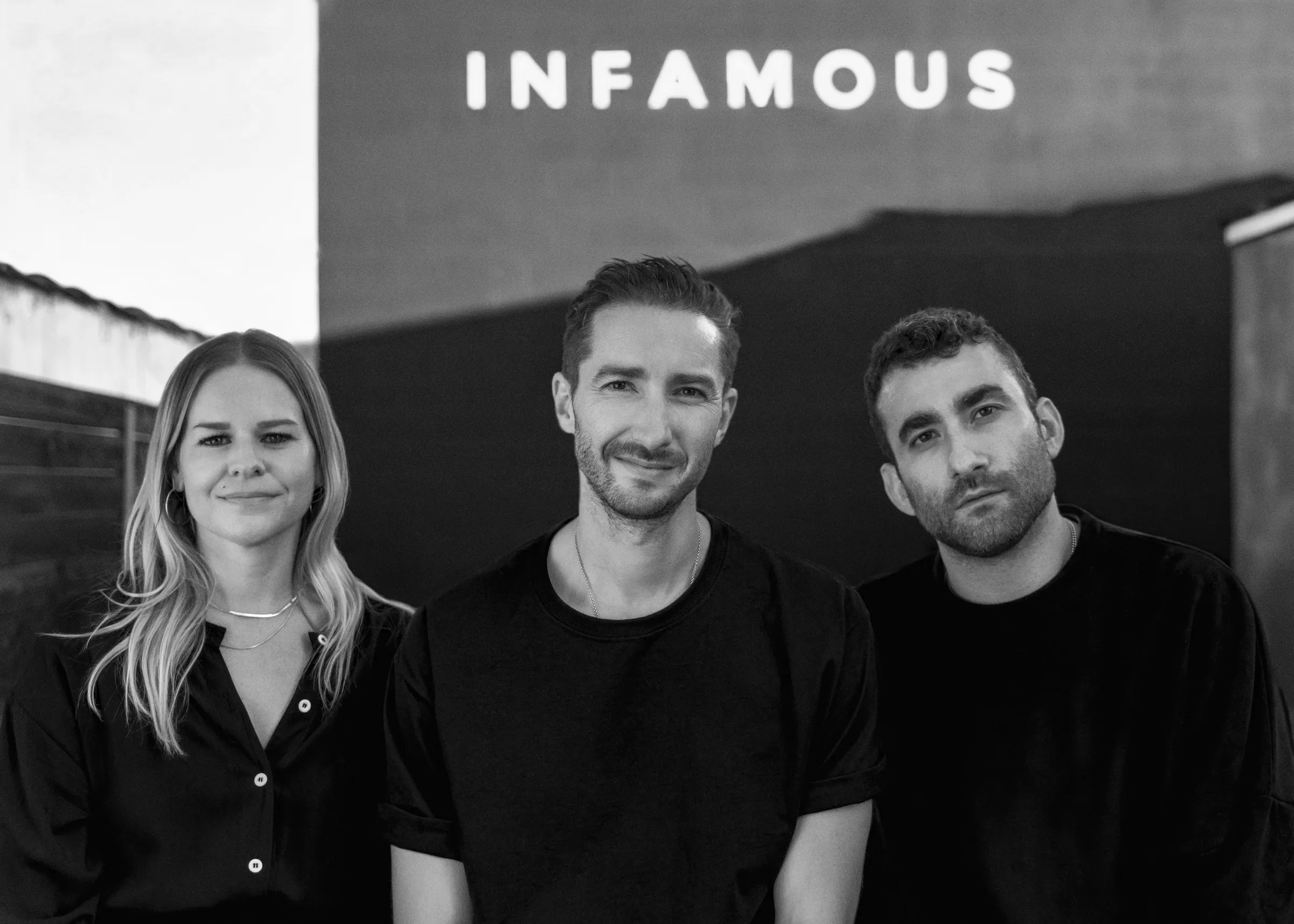 Megan Dembkowski, Alastair Duncan, and Max Frieser standing together outside INFAMOUS