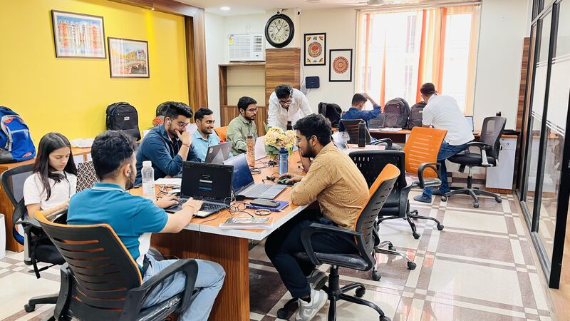Info Origin colleagues working around shared desks in the Dehradun office