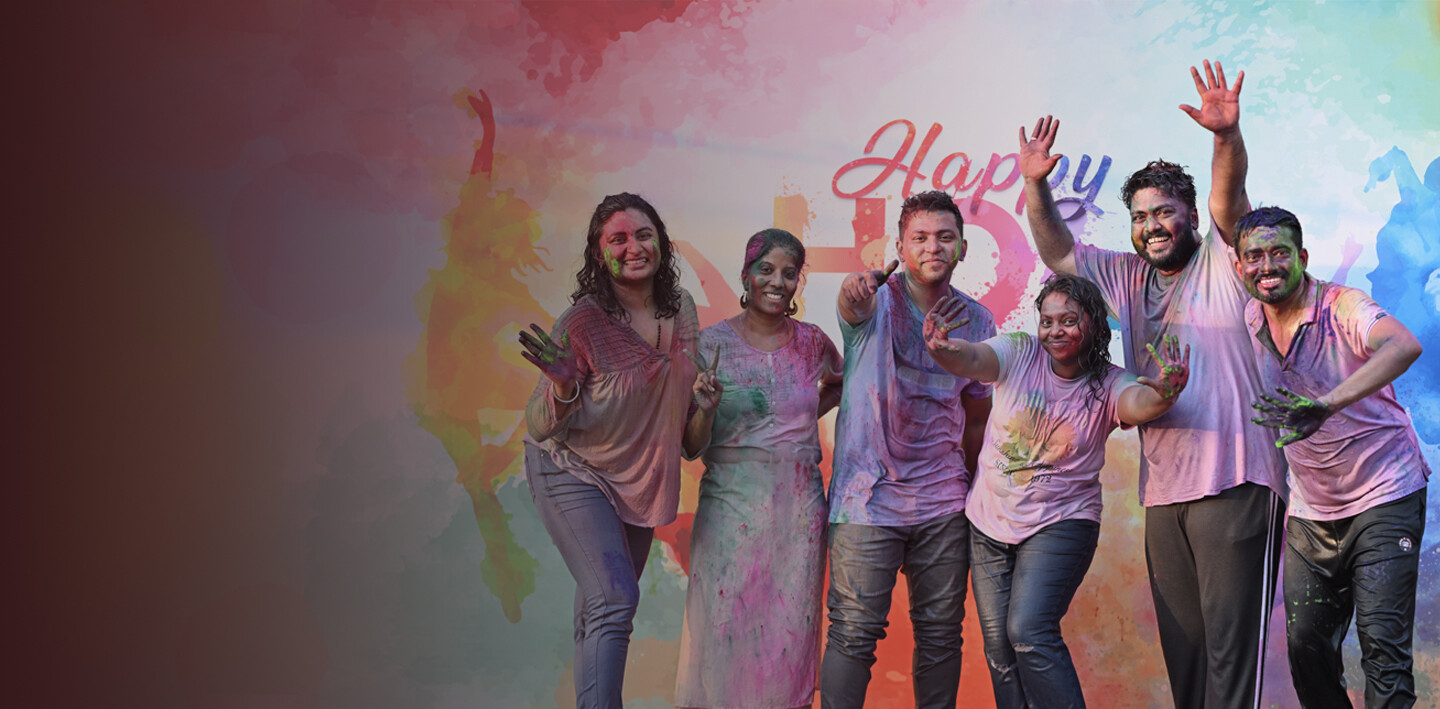Infoblox employees covered in colorful powder at a Holi celebration