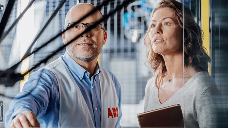 Two people examining equipment in ABB’s published customer-story photograph