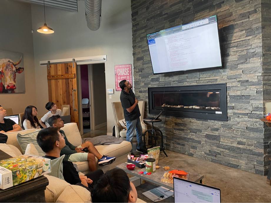 InfStones team members reviewing work on a screen during the 2023 company offsite