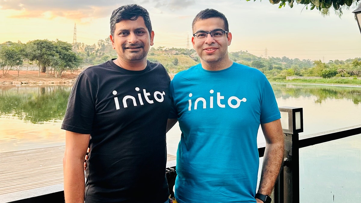 Inito co-founders Varun AV on the left and Aayush Rai on the right beside a lake