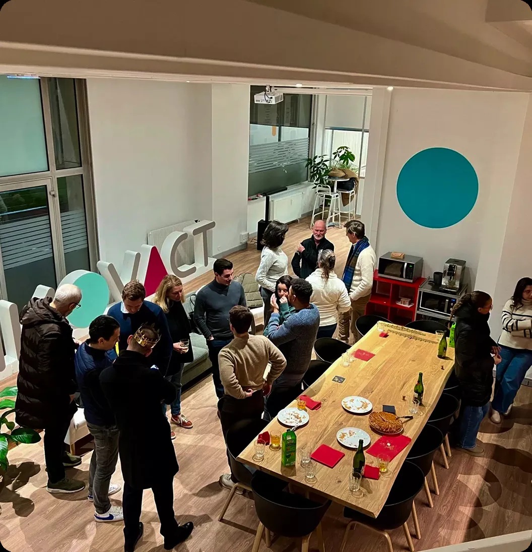 People gathered around a shared table inside INNOVACT’s workspace