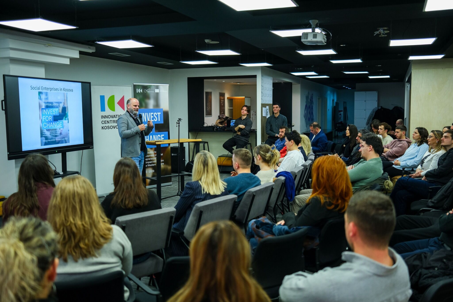 An audience listens to a speaker at the Invest for Change launch inside Innovation Centre Kosovo.