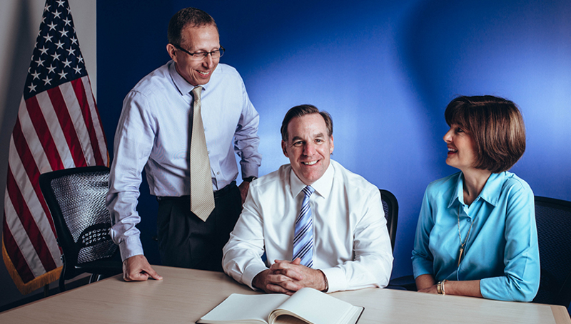 Three members of IDT’s leadership pictured together at a table