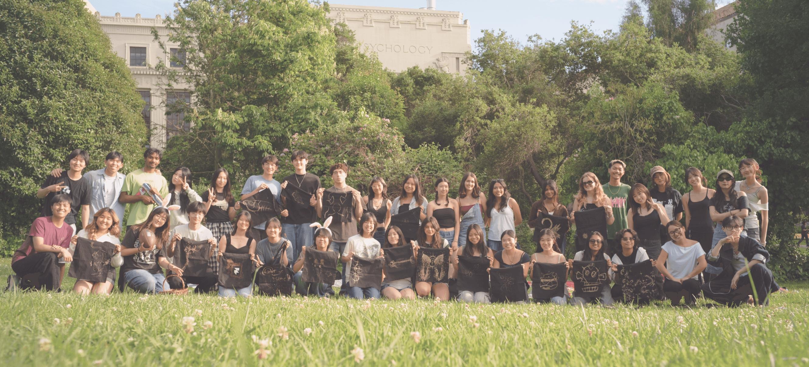 Innovative Design members gathered outdoors on a green lawn