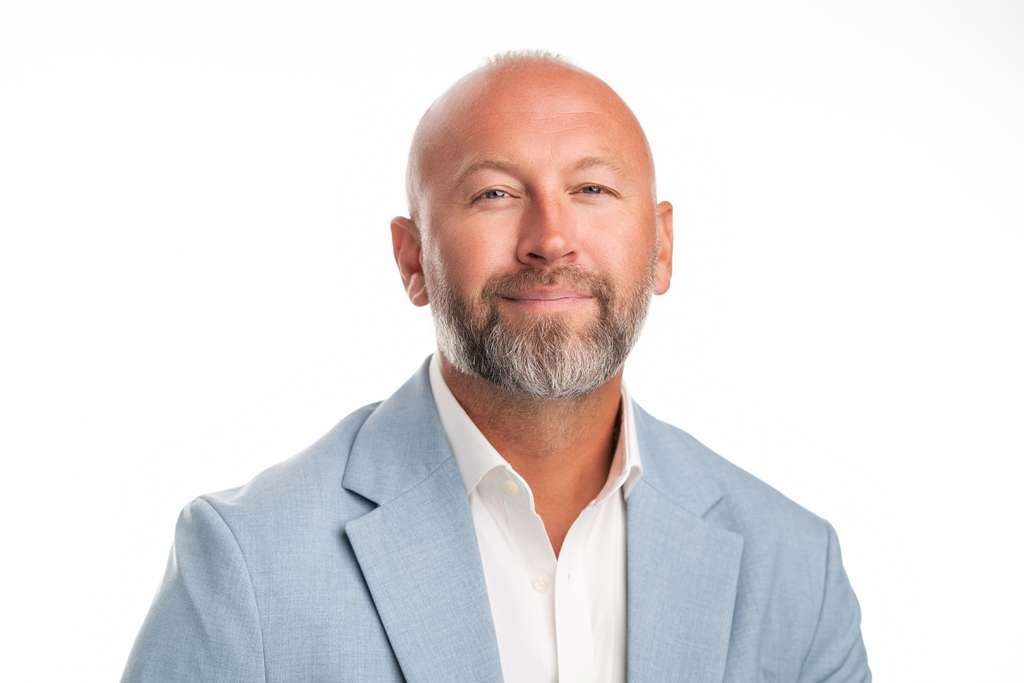 Justin Copie, owner and CEO of Innovative Solutions, in a light blue jacket