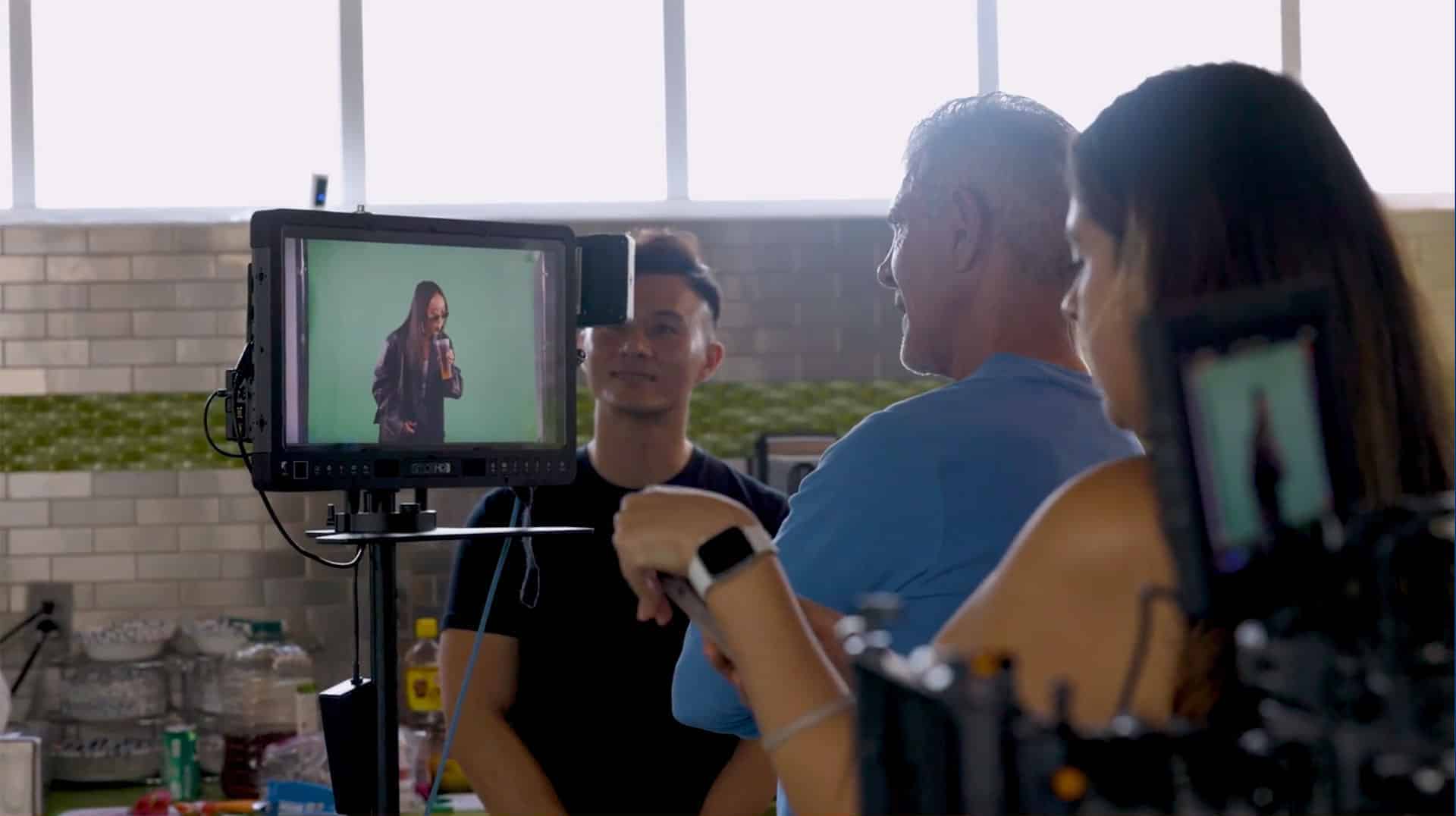 InnoVision team members review footage on a production monitor during a commercial shoot