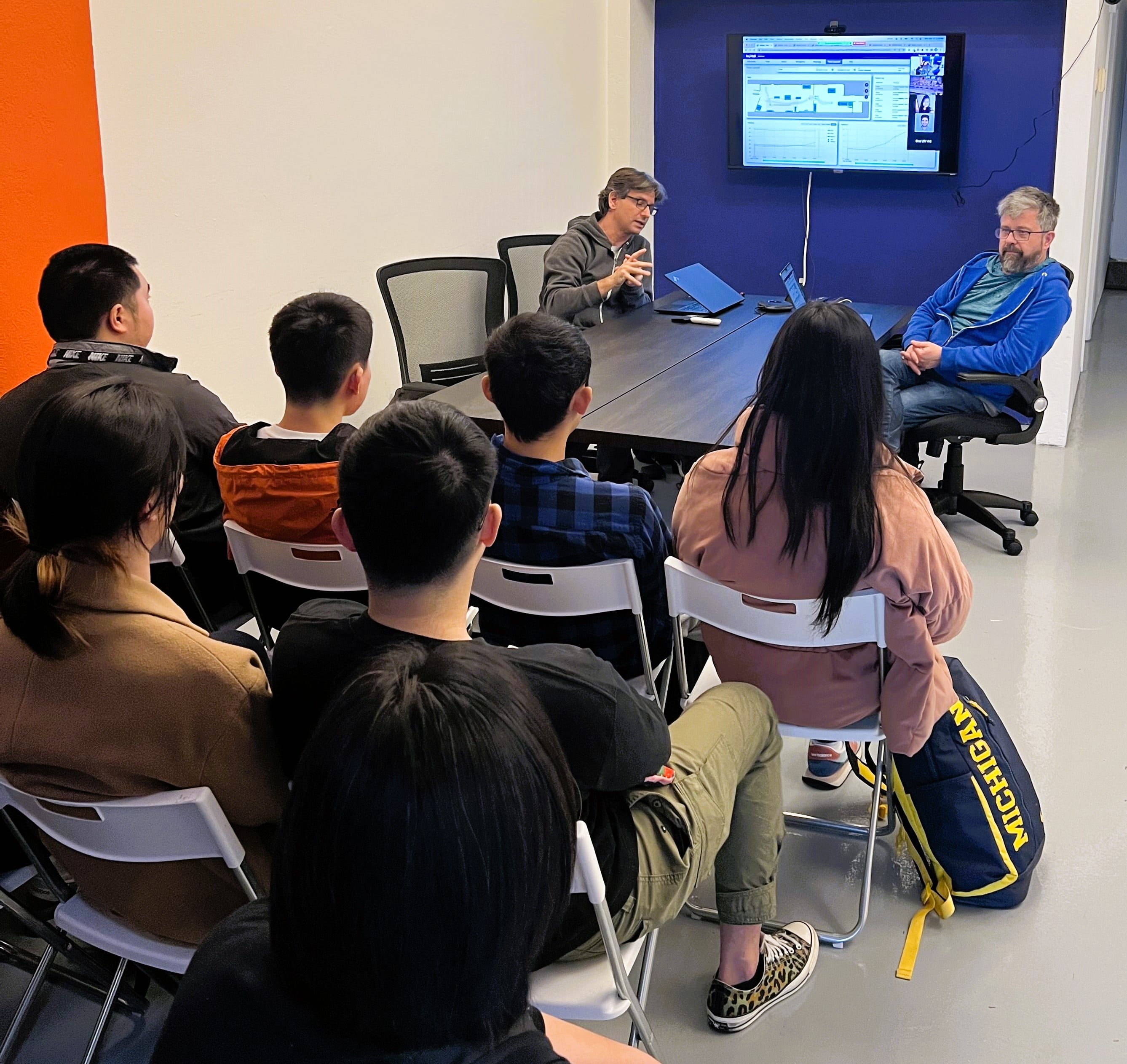 InOrbit founders presenting robot operations software to a seated group at Robot Space