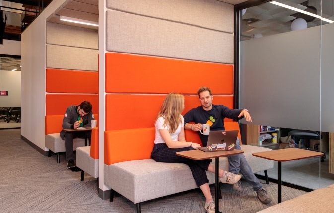 Employees working at a table in Instacart’s Toronto office
