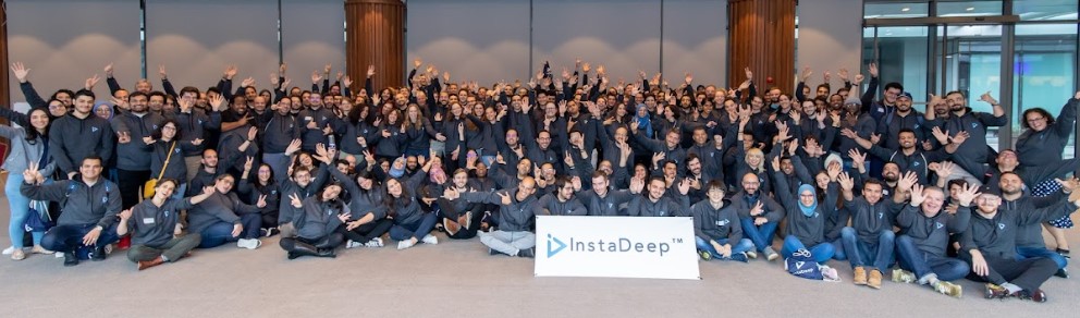 A large group of InstaDeep employees gathered for a team photograph